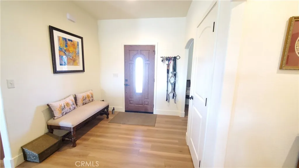 View of front entry area with arched opening to the den/office with front facing window. View of front entry area with arched opening to the den/office with front facing window.