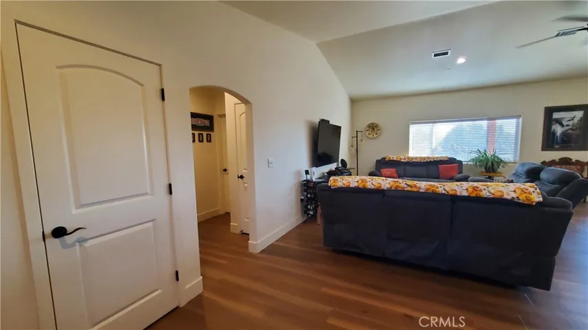 View from entry of arched hallway leading to private guest bedroom & guest bathroom.