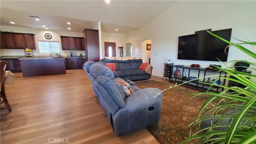 View of living room from the sliding glass door looking toward kitchen & front entry.