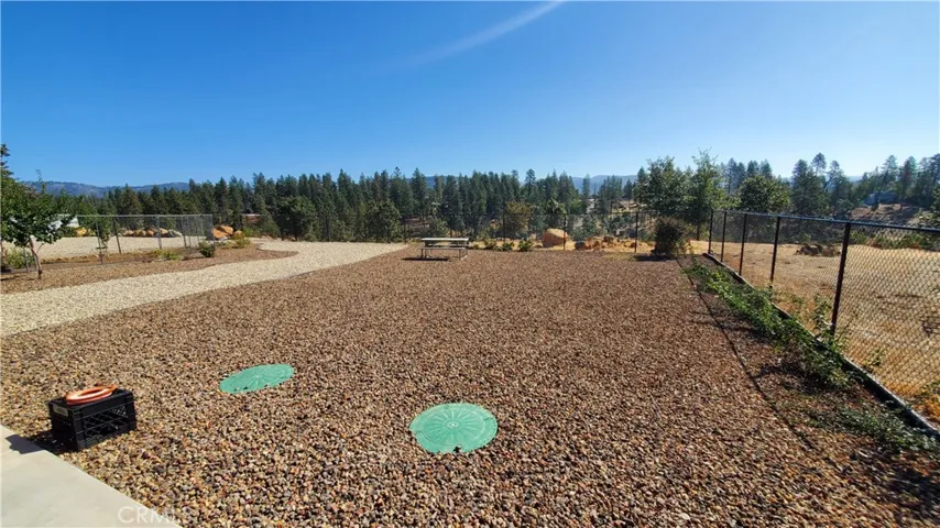 View of fully fenced back yard with views to the East & overlooking Oak Creek Park.