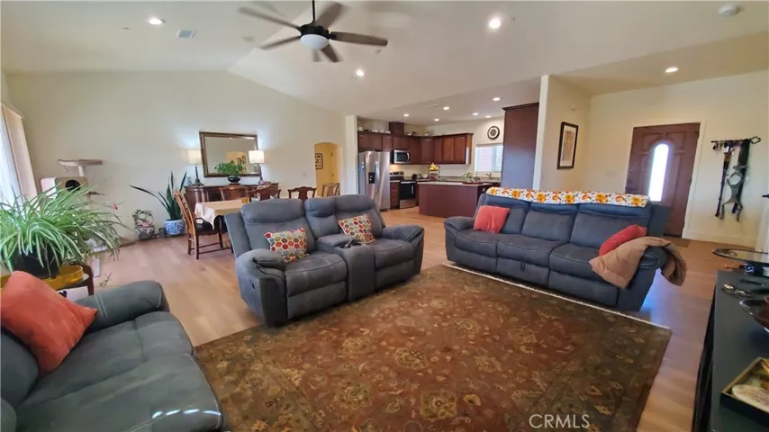 View of open living room area with sliding glass door to the left and front entry on the right.