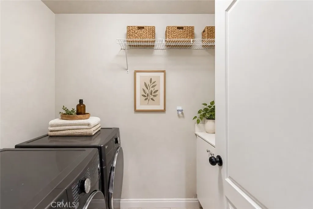 Virtual stage. Downstairs inside laundry room w/utility sink and cabinet storage. Virtual stage. Downstairs inside laundry room w/utility sink and cabinet storage.