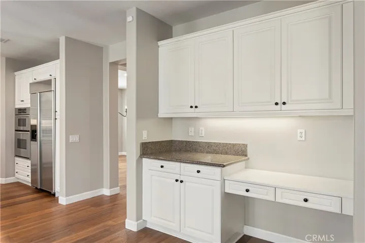 Accessory desk and cabinet space in kitchen.