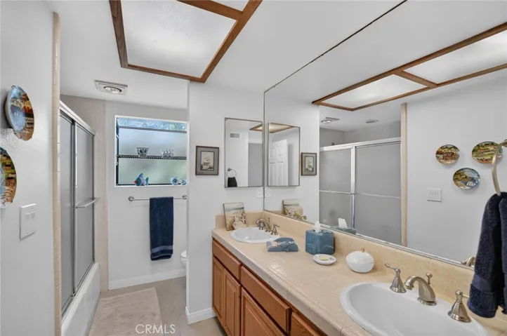 Hallway bathroom with dual sinks