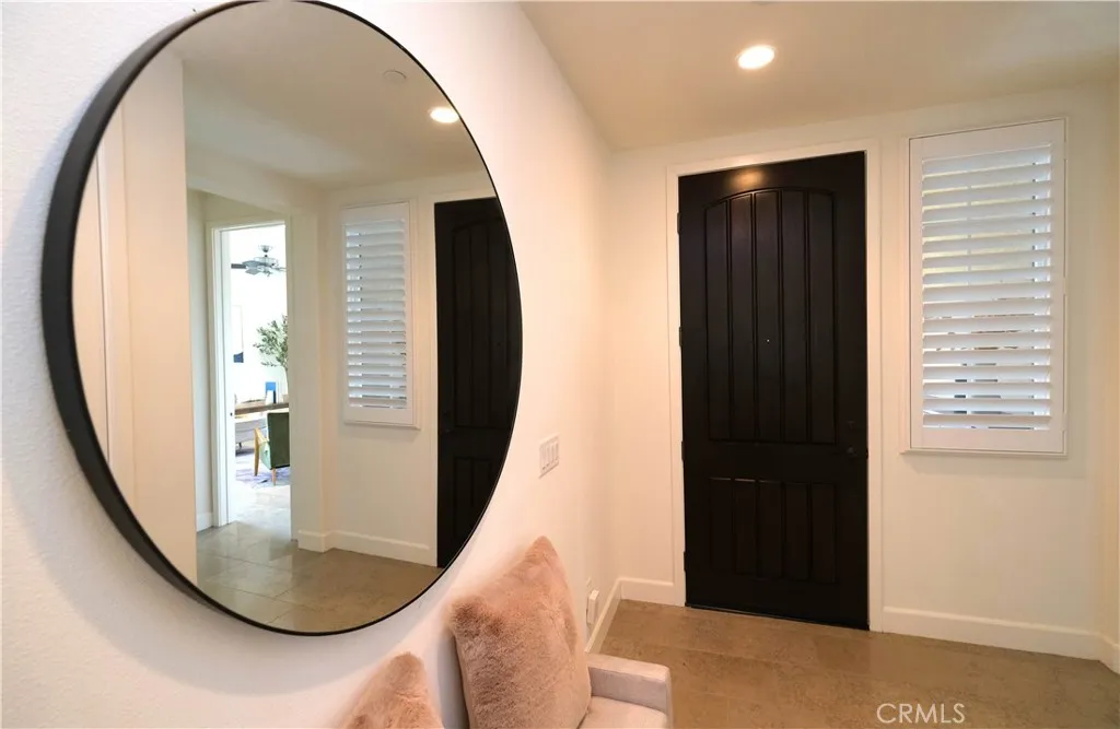 Welcoming foyer with a statement round mirror and an inviting open feel. Welcoming foyer with a statement round mirror and an inviting open feel.
