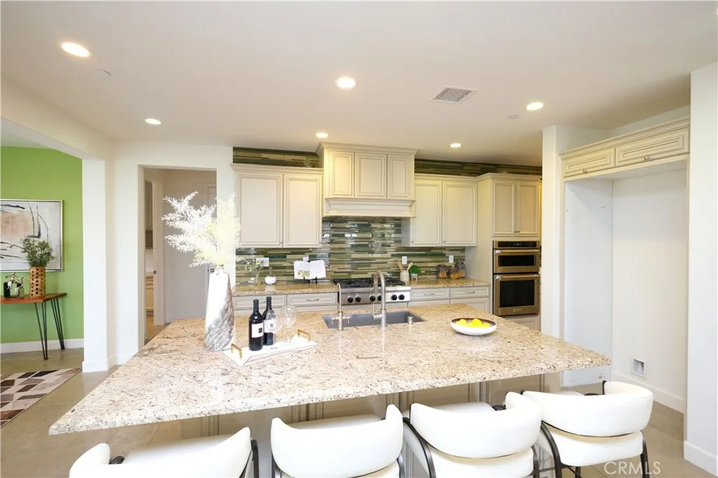 Expansive kitchen island with breakfast-bar seating and ample countertop space. Expansive kitchen island with breakfast-bar seating and ample countertop space.