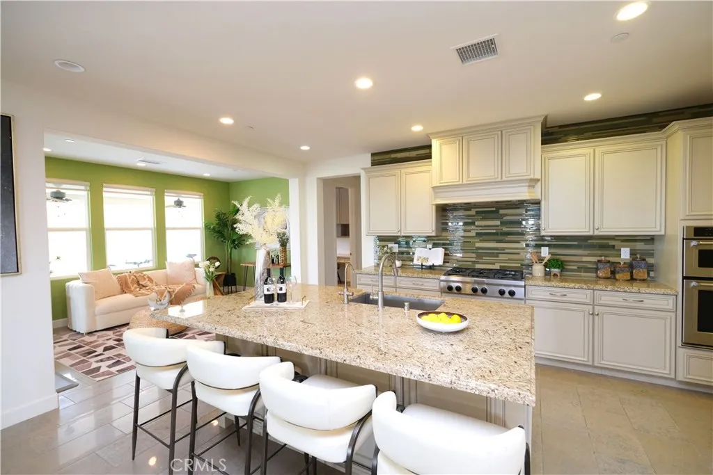 Spacious kitchen featuring a large center island, extensive cabinetry, and built-in appliances. Spacious kitchen featuring a large center island, extensive cabinetry, and built-in appliances.