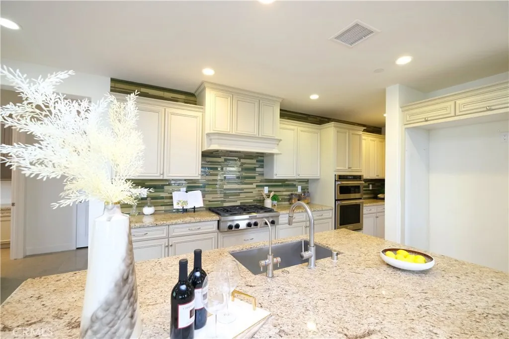 Beautiful appointed kitchen with raised panel cabinetry, stone countertops, and recessed lighting. Beautiful appointed kitchen with raised panel cabinetry, stone countertops, and recessed lighting.