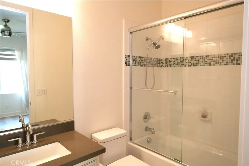 Another view of the bathroom, highlighting the vanity and decorative shower telework. Another view of the bathroom, highlighting the vanity and decorative shower telework.