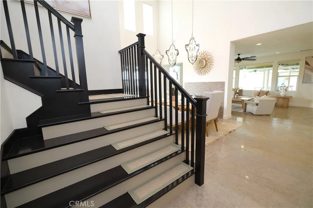 Distinctive staircase featuring dark wood railing and contrasting stair treads and risers. Distinctive staircase featuring dark wood railing and contrasting stair treads and risers.