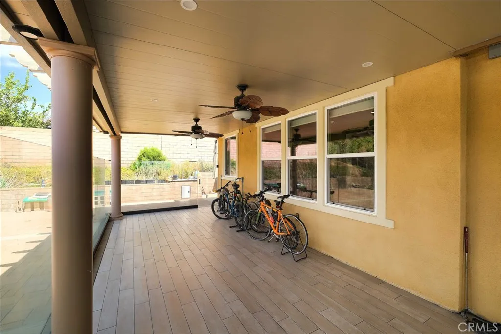 Covered patio with ceiling fans and a sheltered setting for outdoor relaxation. Covered patio with ceiling fans and a sheltered setting for outdoor relaxation.