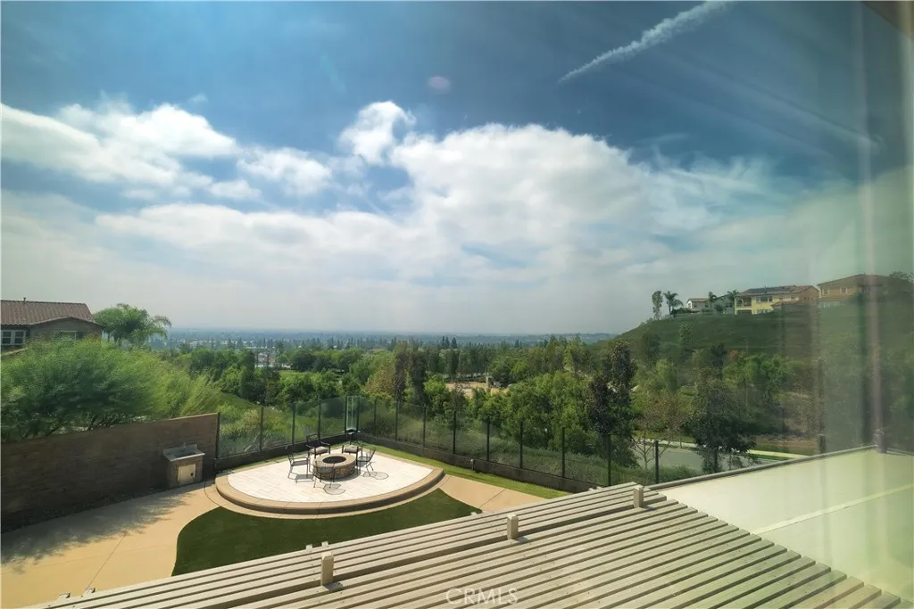 Backyard outlook featuring a circular fire pit and views of the surrounding hills. Backyard outlook featuring a circular fire pit and views of the surrounding hills.