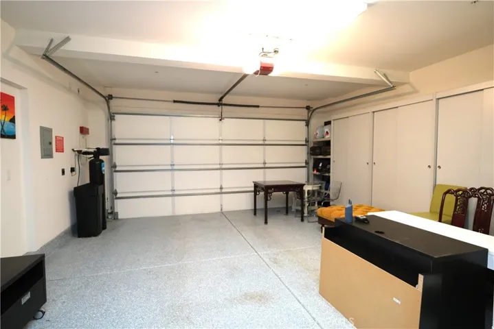 garage interior with an overhead door and space for parking and storage.