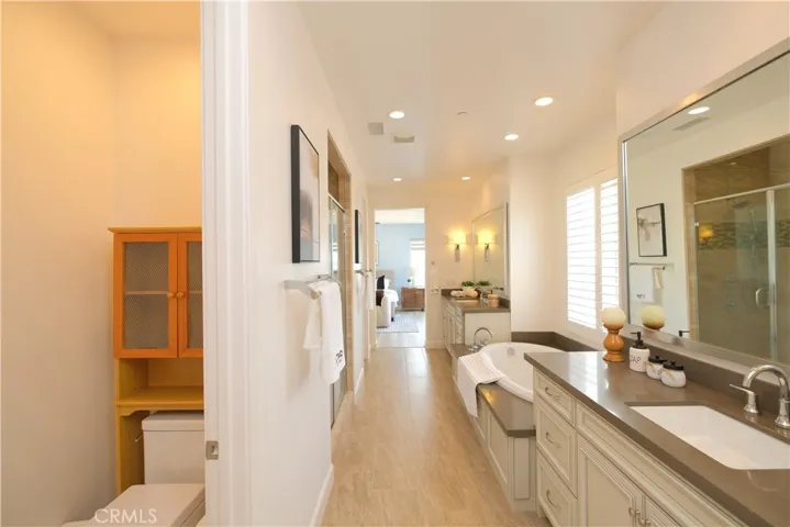 An additional view highlighting the bathroom's extended layout and mirrored vanity area.