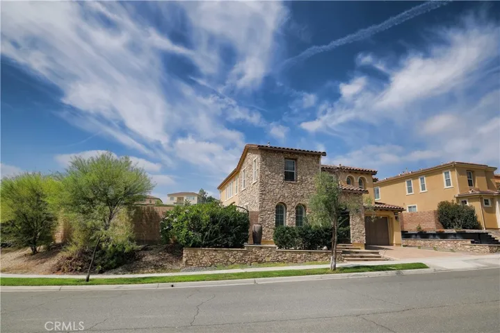 angled exterior view showcasing varied rooflines and established landscaping.