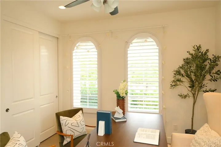 Elegant office space with paired arched windows and abundant natural light.