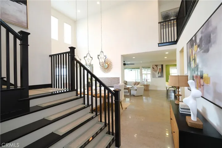 Open entry hall showcasing the staircase and views into the main living areas.