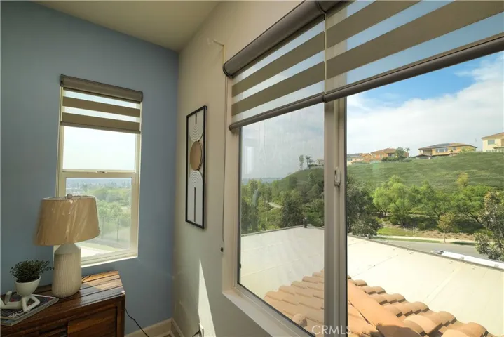 Large windows bring natural light and views of the surrounding greenery into the home