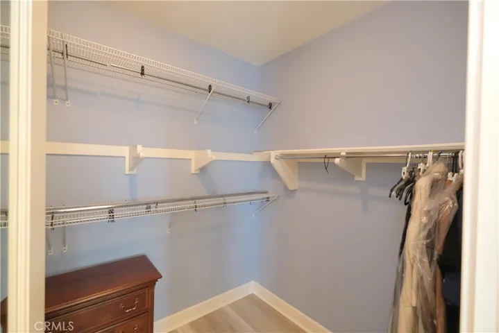 Closet storage view highlighting the bathroom's extended layout and mirrored vanity area.