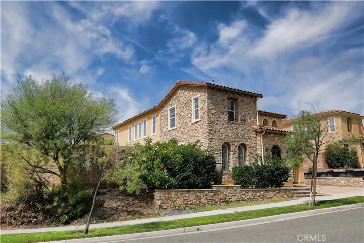 Mature trees and layered landscaping from the home's warm and inviting exterior.
