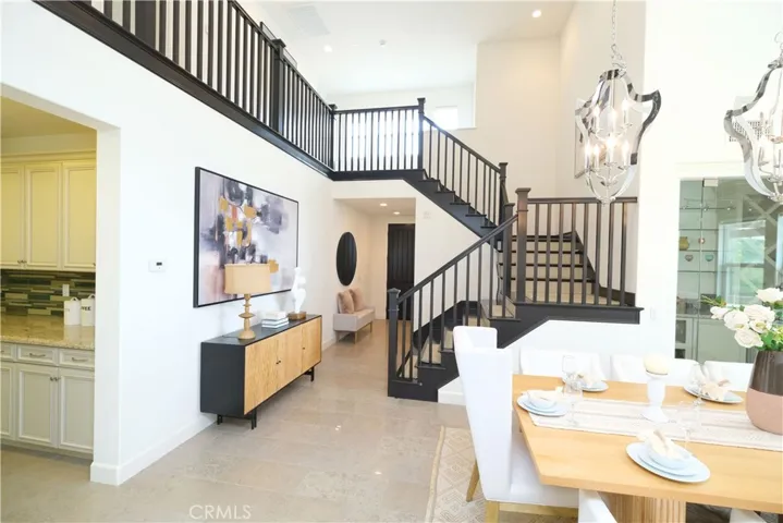 Flowing living and dining areas connected by an open layout and a prominent staircase.