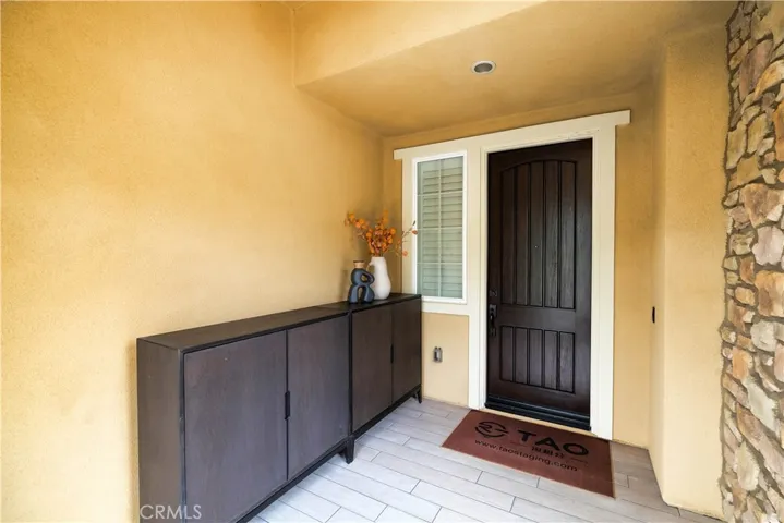 Sheltered entry porch with recessed lighting and a welcoming front doorway.