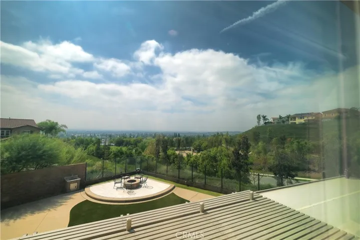 Backyard outlook featuring a circular fire pit and views of the surrounding hills.