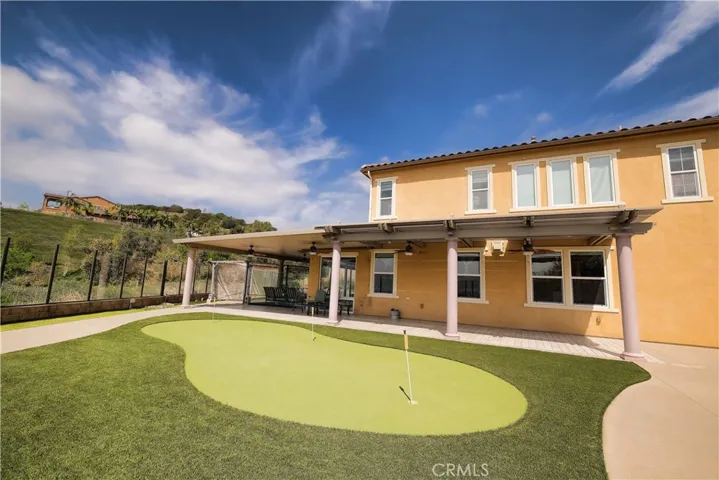 Private putting green adds a recreational touch to the landscaped backyard.