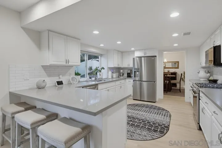 Breakfast bar seating, recessed lighting, and pool/backyard views!