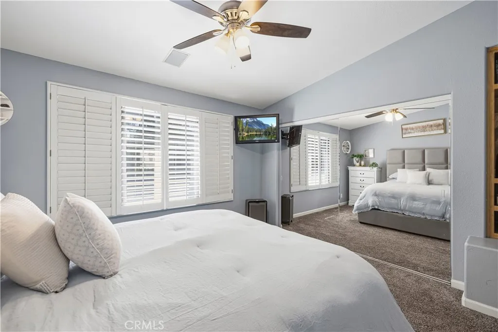 Large mirrored closet, plantation shutters & ceiling fan. Large mirrored closet, plantation shutters & ceiling fan.