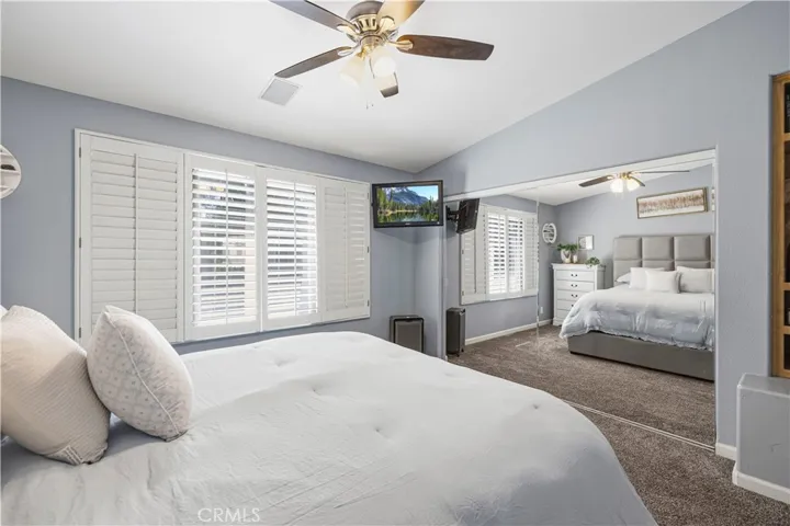 Large mirrored closet, plantation shutters & ceiling fan.