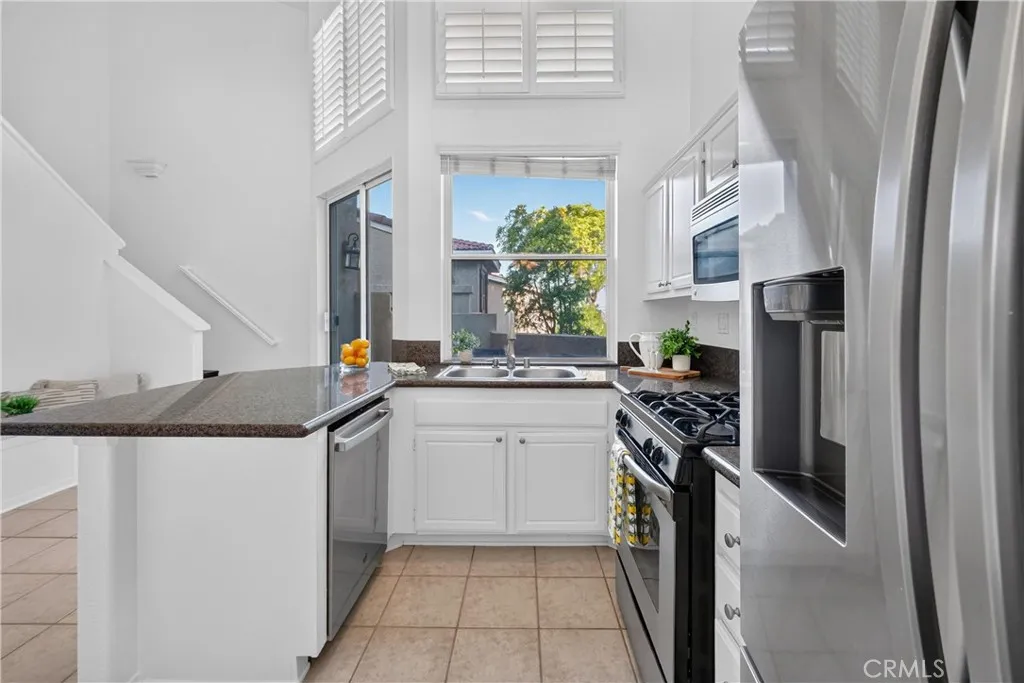 White wood cabinetry, stainless steal appliances and granite counter tops with lots of natural light White wood cabinetry, stainless steal appliances and granite counter tops with lots of natural light