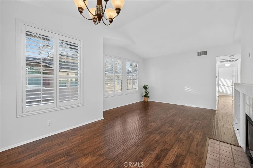 Living space with fireplace, plantation shutters, new windows, new paint and hard wood floors. Living space with fireplace, plantation shutters, new windows, new paint and hard wood floors.