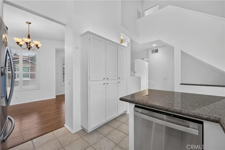 Full size pantry and view to stair case to 3rd bedroom with full bath