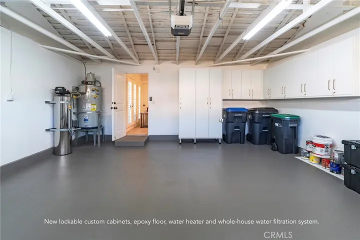 New epoxy floor, insulated garage door, lockable cabinets, new water heater, whole-house water filtration system