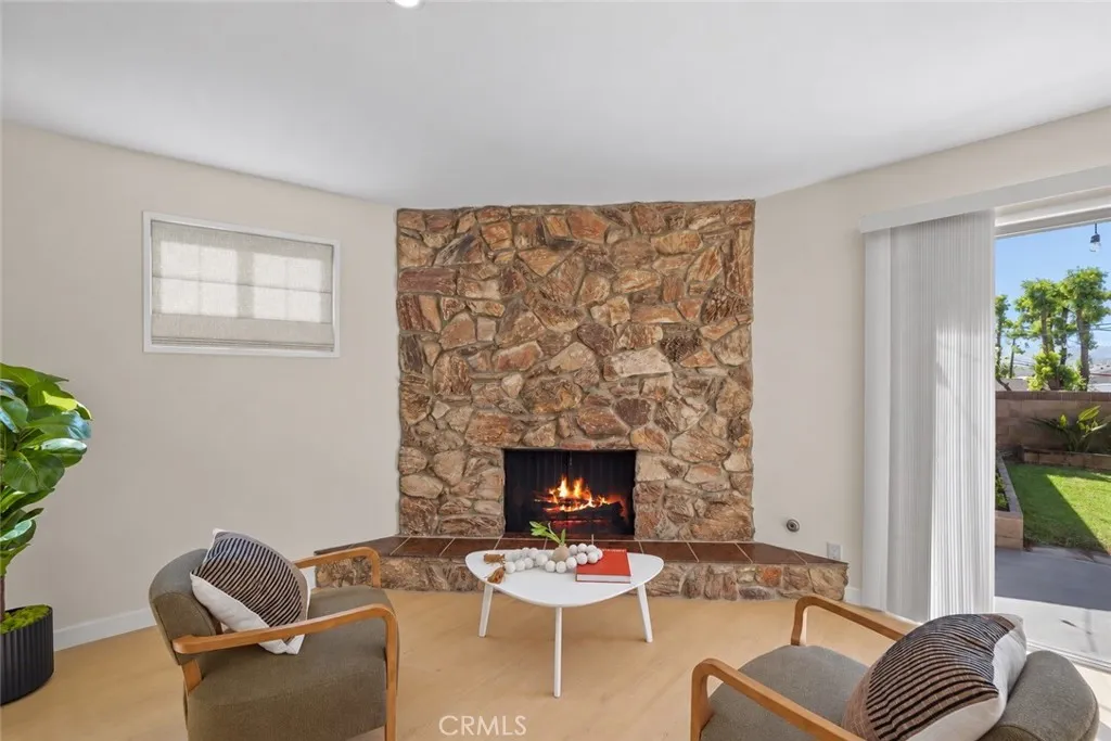 Virtually staged flame added to the fireplace and virtually staged blind on the window Virtually staged flame added to the fireplace and virtually staged blind on the window