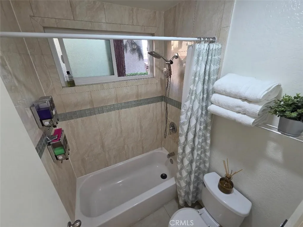 shower in tub has tiled walls shower in tub has tiled walls