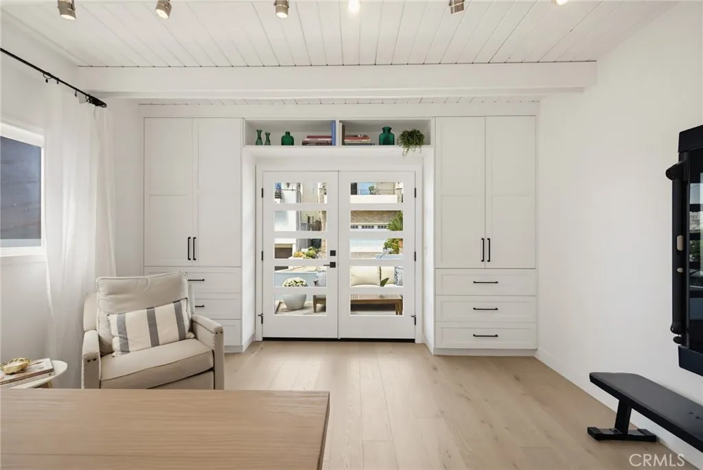 Thoughtfully designed cabinetry surrounding the French doors provide hanging closet space shelves and drawers. No additional furniture needed. Thoughtfully designed cabinetry surrounding the French doors provide hanging closet space shelves and drawers. No additional furniture needed.