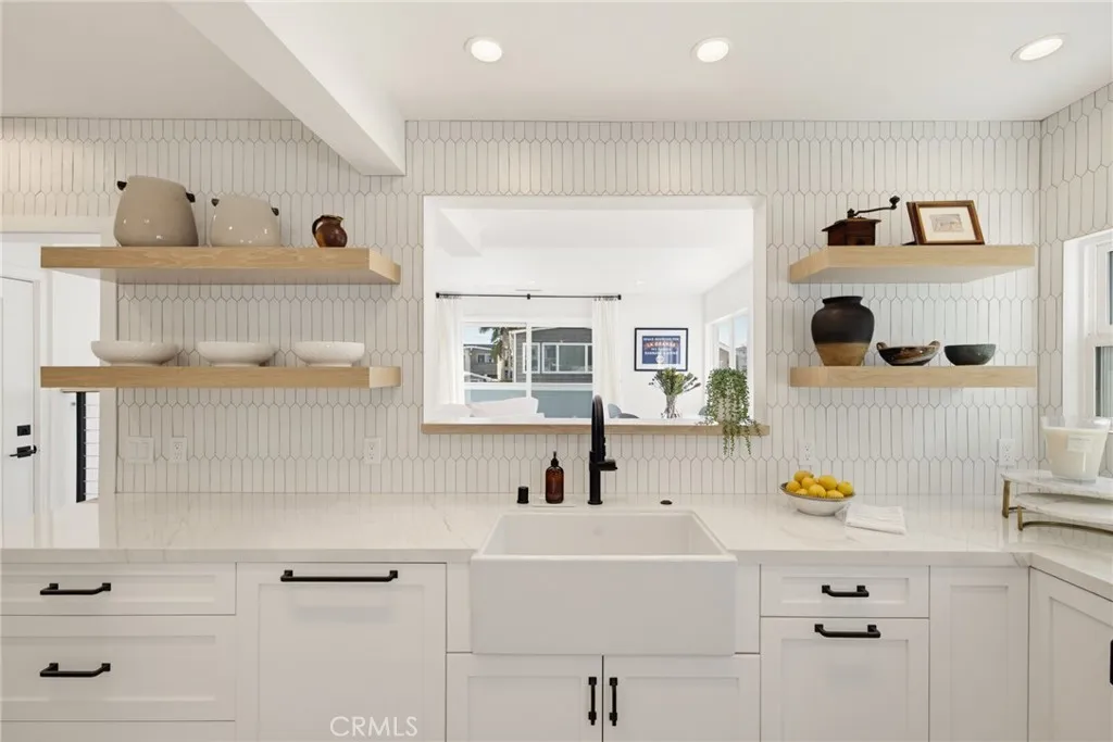 A Shaw farmhouse sink, a really cool pass thru from the kitchen to the family room, and just enough open display shelving for your essentials or just a few of your beautiful things. A Shaw farmhouse sink, a really cool pass thru from the kitchen to the family room, and just enough open display shelving for your essentials or just a few of your beautiful things.