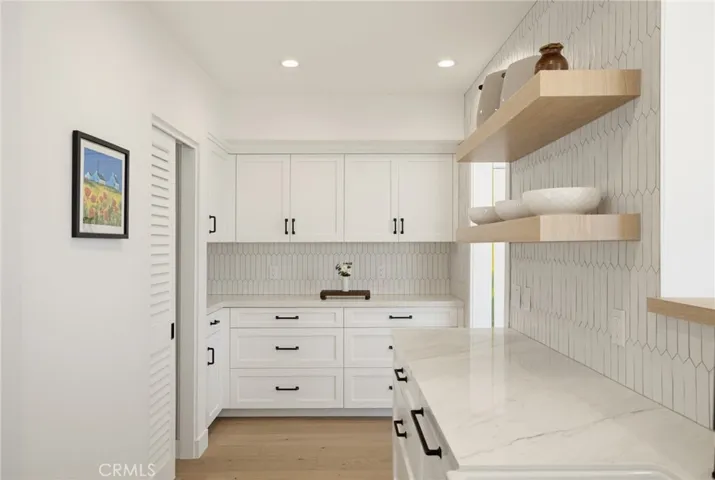 Kitchen wiith a view towards the stack laundry area at the left, and even more storage and counter space straight ahead