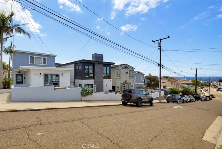 Situated on a wide quiet one-way street, with ocean views that start before you even step inside...perfect curb appeal because the garage is in the rear of this "street to street" lot.