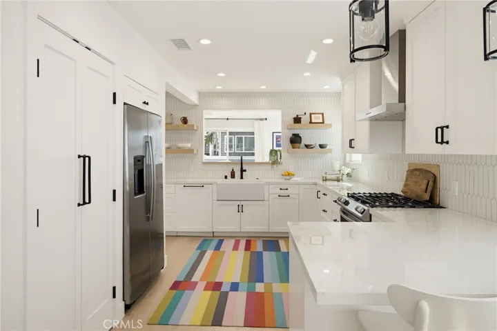 So much counter space, and that's a double door, reach/step-in pantry to the left of the refrigerator.