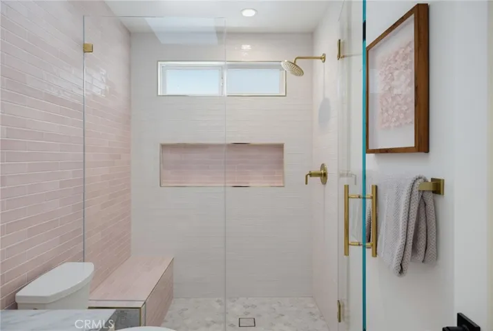 Main level bathroom with large shower and niche detail for all your pretty things