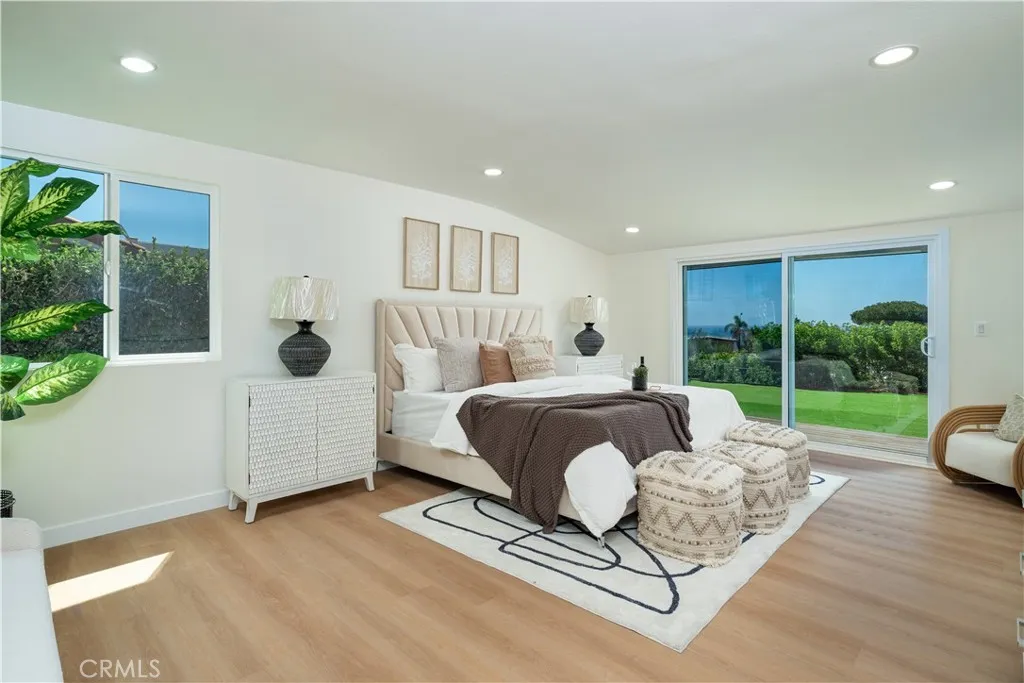 Spacious primary bedroom with ocean view.