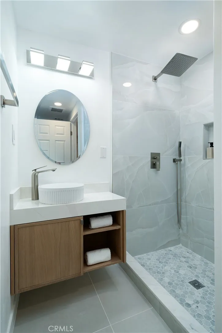 Powder room with shower in the hallway.