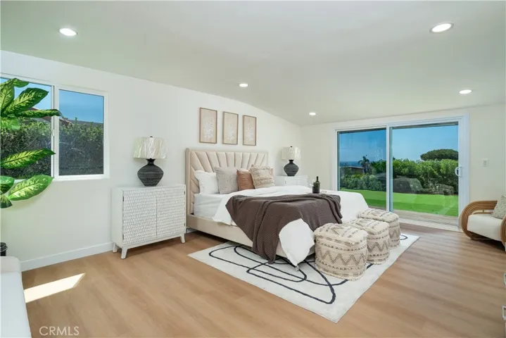 Spacious primary bedroom with ocean view.