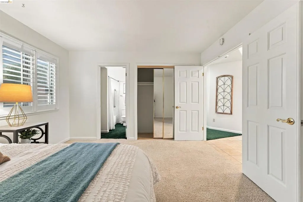 Window with plantation shutters, mirrored closet doors, and panel doors
