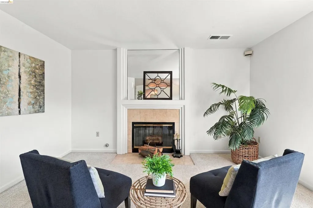Fireplace with a stone surround, black firebox, and white mantel