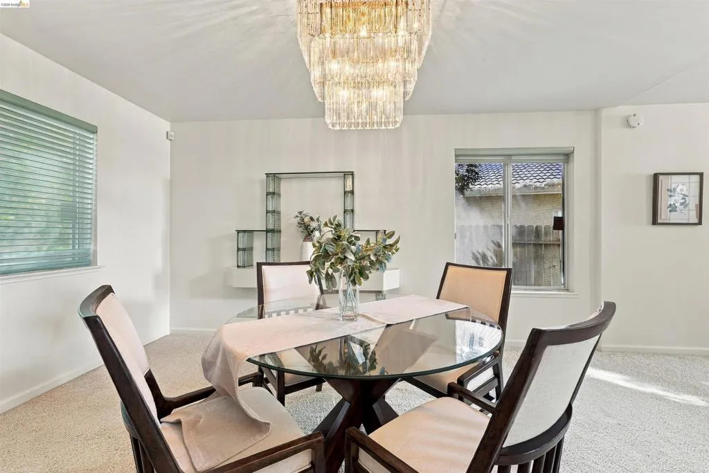 Statement chandelier, built-in shelving, and neutral wall color