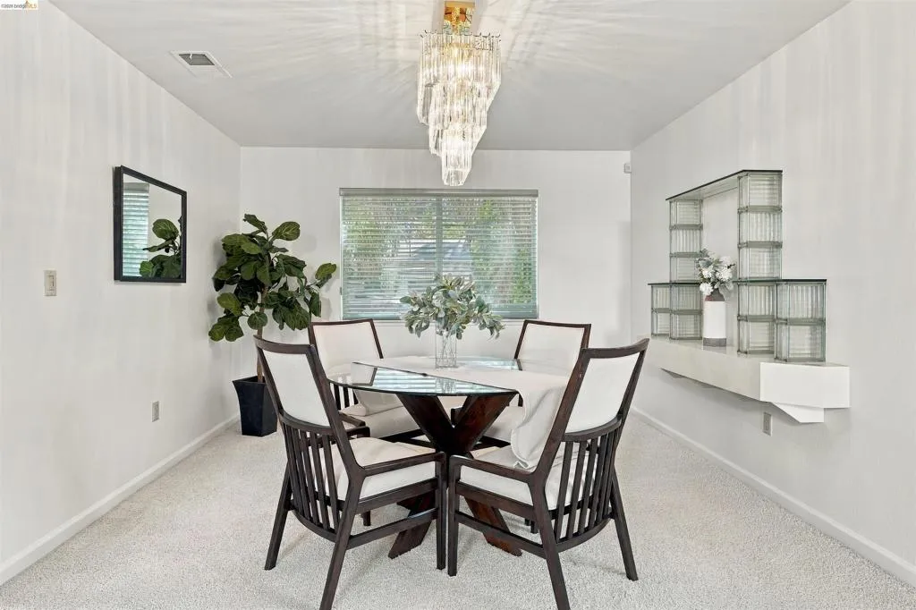 Recessed lighting, window with blinds, wall-mounted glass block shelving, and wall-to-wall carpeting